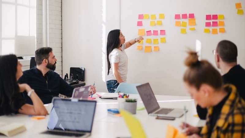 Creative team evaluating different project management solutions